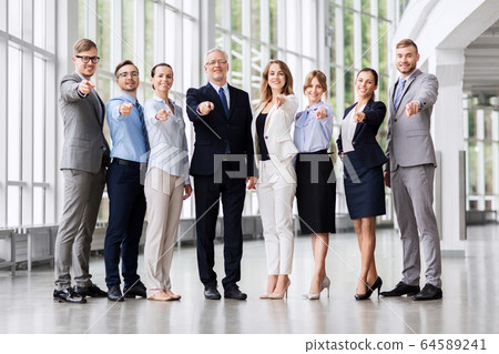 business people pointing to camera at office business people pointing to camera at office 64589241