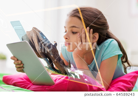 girl with tablet pc learning nature online at home girl with tablet pc learning nature online at home 64589243