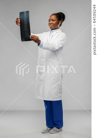 african american female doctor looking at x-ray african american female doctor looking at x-ray 64589244