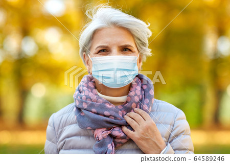 senior woman in protective medical mask at park senior woman in protective medical mask at park 64589246