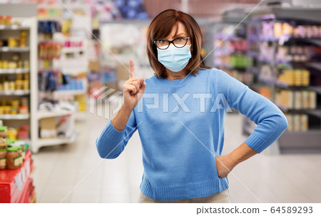 angry senior woman in medical mask at supermarket 64589293