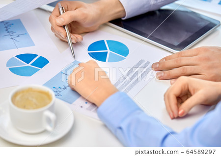 business team hands with pens and charts at office business team hands with pens and charts at office 64589297