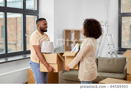 happy couple with boxes moving to new home happy couple with boxes moving to new home 64589303