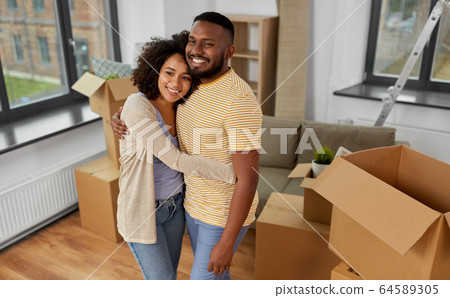 happy couple with boxes moving to new home 64589305