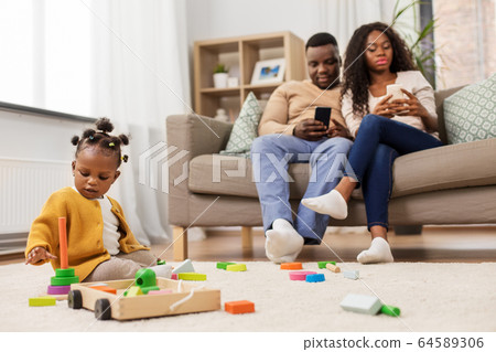 african baby girl playing with toy blocks at home african baby girl playing with toy blocks at home 64589306