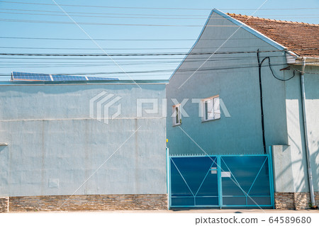 Blue house exterior in Hunedoara, Romania 64589680