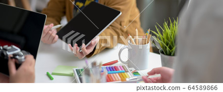 Cropped shot of designer team consulting on their Cropped shot of designer team consulting on their 64589866
