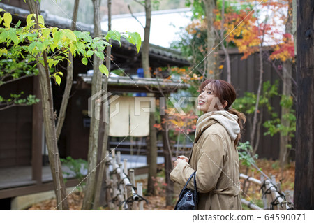 Woman enjoying a hot spring trip Woman enjoying a hot spring trip 64590071