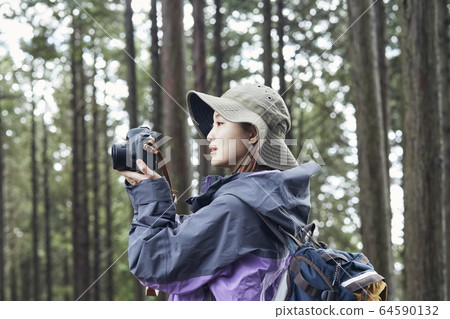 Woman taking pictures in the mountains Woman taking pictures in the mountains 64590132