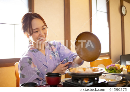 Woman enjoying a hot spring trip Woman enjoying a hot spring trip 64590275