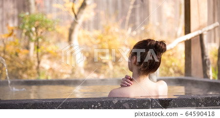 Woman enjoying a hot spring trip Woman enjoying a hot spring trip 64590418