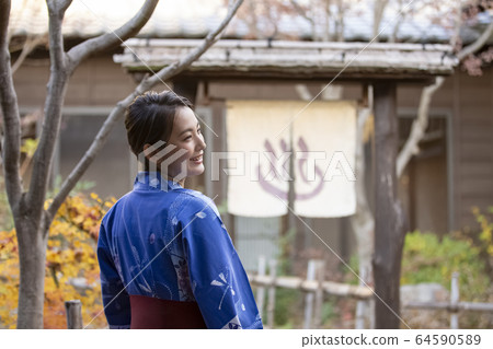 Woman enjoying a hot spring trip Woman enjoying a hot spring trip 64590589