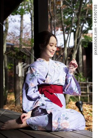 Woman enjoying a hot spring trip Woman enjoying a hot spring trip 64590788