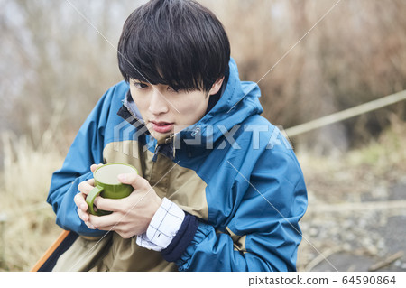 A man resting in the mountains A man resting in the mountains 64590864