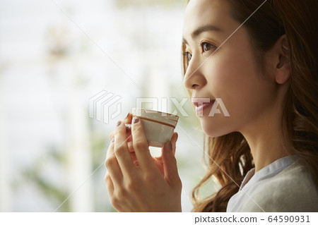 A woman drinking alcohol A woman drinking alcohol 64590931