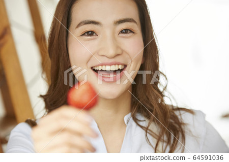A woman eating fruit 64591036