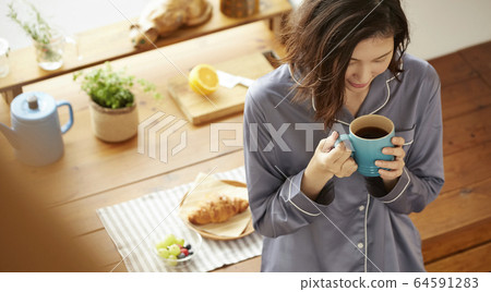 A woman drinking coffee A woman drinking coffee 64591283