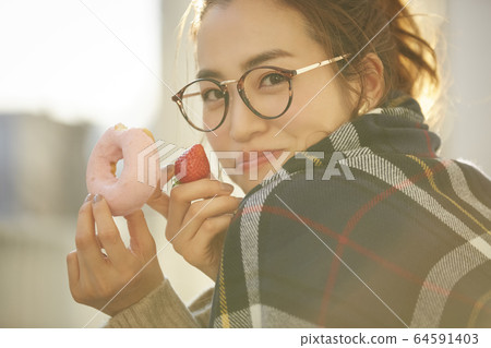 Woman enjoying a snack Woman enjoying a snack 64591403