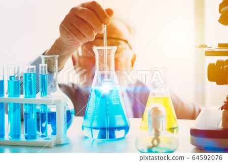 Scientist looking focus on new chemical vaccine formula successful to discover science research drug Scientist looking focus on new chemical vaccine formula successful to discover science research drug 64592076