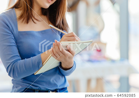 Business owner checking inventory stock for order new products for manager report fashion shop 64592085