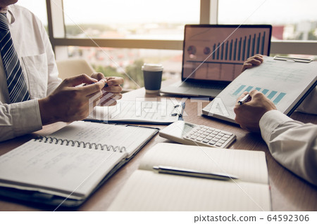 Businessmen explain about quarterly results with 64592306