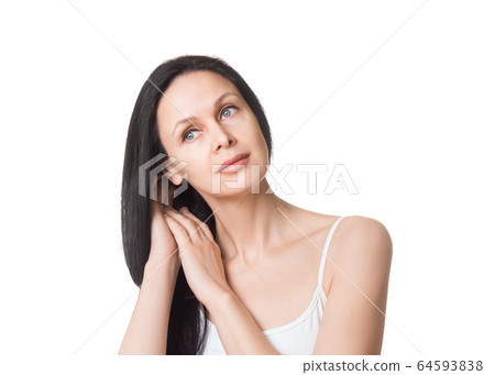 Caucasian attractive female face with long loose black hair and bare shoulders, close up. Adult woman touches her hair with hands, natural beauty, isolated on white. Caucasian attractive female face with long loose black hair and bare shoulders, close up. Adult woman touches her hair with hands, natural beauty, isolated on white. 64593838