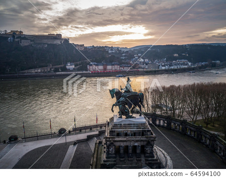 Colorful Sunrise burning sky Koblenz City historic monument German Corner where river rhine and mosele flow together Colorful Sunrise burning sky Koblenz City historic monument German Corner where river rhine and mosele flow together 64594100