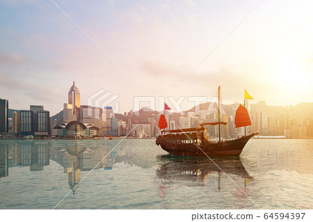 Hong Kong skyline with a traditional boat. Hong Kong skyline with a traditional boat. 64594397