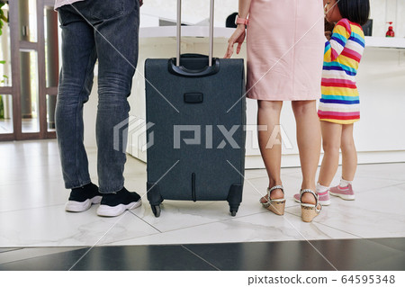 Family at hotel reception Family at hotel reception 64595348