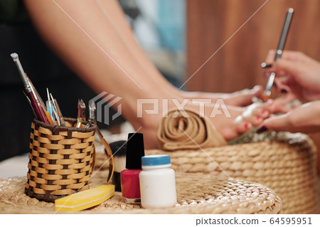 Wicker holder with pedicure tools 64595951