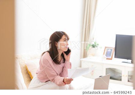 A woman looking at a document A woman looking at a document 64599243
