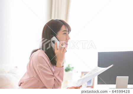 A woman confirming a document 64599428