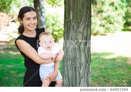 Happy mother and daughter laughing together outdoors. Happy mother and daughter laughing together outdoors. 64601304