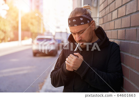 Handsome young unshaven man black hoodie and Handsome young unshaven man black hoodie and 64601663