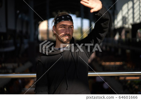Handsome young unshaven man black hoodie and Handsome young unshaven man black hoodie and 64601666