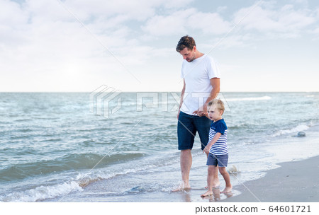 Young Caucasian dad with little son walk warm Young Caucasian dad with little son walk warm 64601721