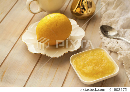 Lemon zest with zester behind zest. Grated and ground lemon, healhty food Lemon zest with zester behind zest. Grated and ground lemon, healhty food 64602375