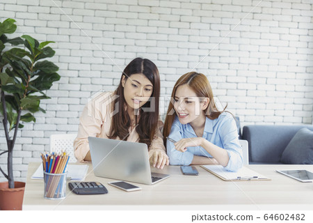 Happy entrepreneur asian businesswomen using Happy entrepreneur asian businesswomen using 64602482