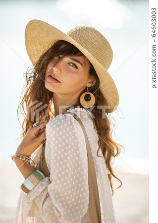 Woman Resting on the Beach During Vacation Woman Resting on the Beach During Vacation 64603003