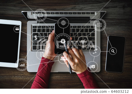 Top view business hand working with laptop computer, tablet and smart phone in office with digital marketing media  in virtual icon 64603212