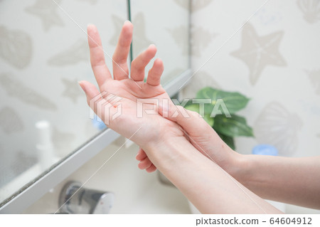 Women painting hand cream 64604912