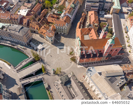 Aerial drone view of Preseren Squere and Triple Bridge over Ljubljanica river,Tromostovje, Ljubljana, Slovenia. Empty streets during corona virus pandemic social distancing measures Aerial drone view of Preseren Squere and Triple Bridge over Ljubljanica river,Tromostovje, Ljubljana, Slovenia. Empty streets during corona virus pandemic social distancing measures 64605032