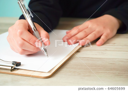 Person taking notes on paper 64605699