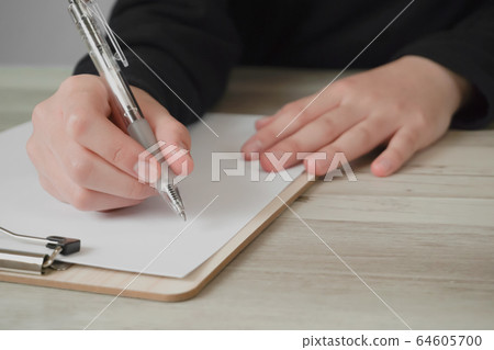 Person taking notes on paper Person taking notes on paper 64605700