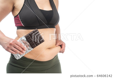 Woman with excess fat on her stomach with chocolate in hand. Conceptual image of obesity. Side view. Isolated on a white background. 64606142