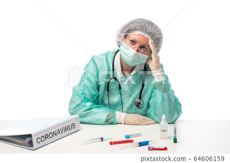Tired nurse in laboratory of the hospital sitting at the table. Archive folder for the virus Covid-19 Tired nurse in laboratory of the hospital sitting at the table. Archive folder for the virus Covid-19 64606159