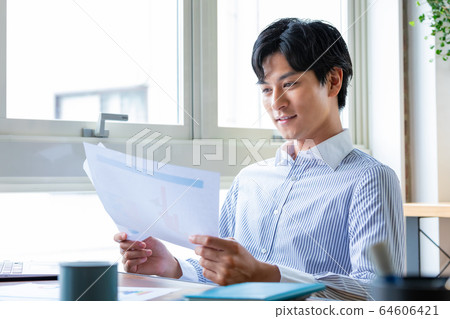 Businessman looking at materials Telework Businessman looking at materials Telework 64606421