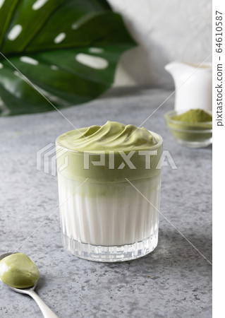 Dalgona Iced Matcha tea on grey. 64610587