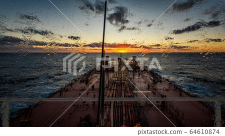 Main deck of large crude oil tanker through rainy window 64610874