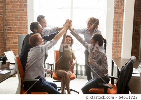 Motivated happy diverse office people group giving high five Motivated happy diverse office people group giving high five 64611722